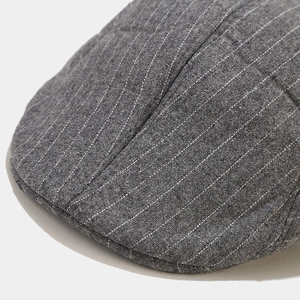 Close-up detail of grey striped newsboy cap showing premium wool blend texture