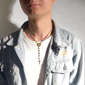 Turkish evil eye necklace with colorful beads worn by a model in natural lighting