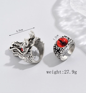 Detail of vintage silver dragon ring and red evil eye ring set with weight information