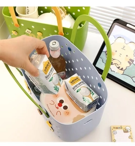 Detail shot of a plastic hollow bath basket showing storage capacity with hand action