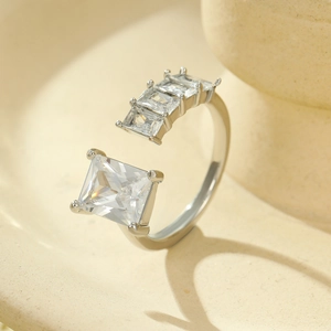 Detailed close-up of a silver adjustable ring featuring square-cut clear cubic zirconia