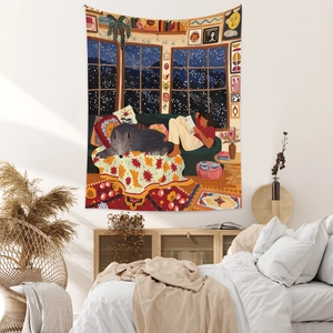 Detailed view of bohemian tapestry featuring a cozy winter reading illustration on bedroom wall