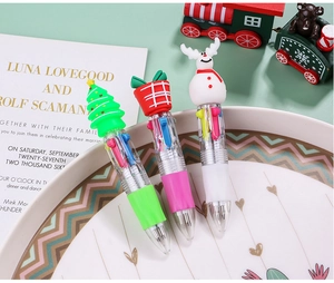 Close-up of three 6-color Christmas ballpoint pens with Santa, elk and tree toppers