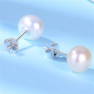 Macro shot of 8-10mm white freshwater pearl earrings with S925 silver butterfly backs