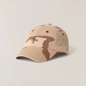 Detailed view of desert camo baseball cap featuring cross embroidery and metal eyelets