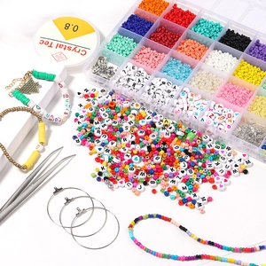 Macro view of 24-grid DIY jewelry kit with colorful seed beads and alphabet charms