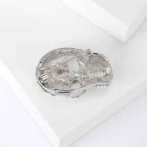 Detailed back view of silver skull brooch showing secure pin fastener mechanism