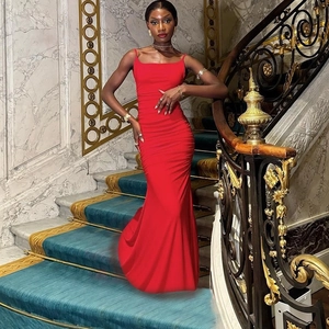 Detailed view of elegant red strapless maxi dress on luxury staircase background