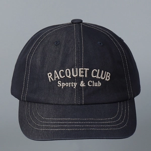 Close-up of navy blue baseball cap with grey Racquet Club embroidery and cotton texture
