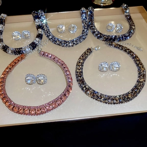 Detailed close-up of multiple crystal necklace and earring sets in various elegant colors