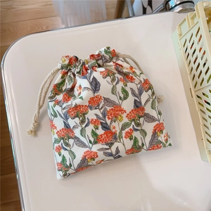 Detail of floral cotton drawstring bag with oil painting style print and cream rope