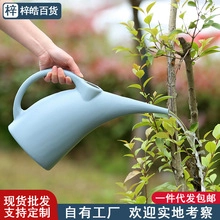 Macro detail of a light blue watering can with a long spout for precision home gardening