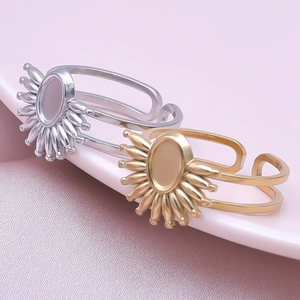 Detailed macro view of gold and silver sunflower adjustable ring bases with oval bezels