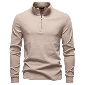 Close-up of khaki half-zip stand collar sweatshirt showing soft fleece texture and stitching