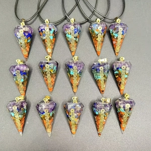 Seven chakra orgonite pendants with natural crystal stones in a 15-piece grid arrangement
