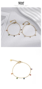 Detail of gold titanium steel bracelets with colorful and white zircon inlay and lobster clasp