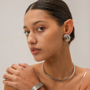 Close-up of model wearing silver fish scale earrings and minimalist choker necklace