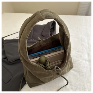 Interior view of large army green faux suede tote bag with drawstring and daily essentials