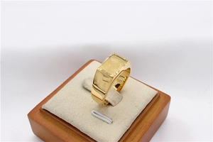 Detailed macro view of high-polished golden rectangular signet ring for men