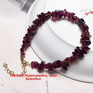 Detail of garnet chip bracelet with 14K gold filled lobster clasp and heart charm