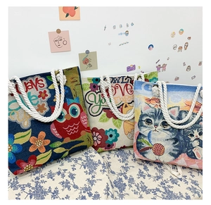 Three jacquard tote bags with cat, owl and floral patterns with cotton rope handles