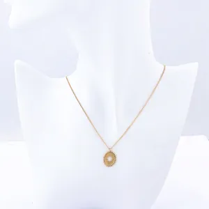 Elegant gold oval pendant necklace with starburst engraving and classic rope chain