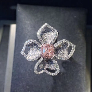 Luxury floral cocktail ring with a pink center stone and white diamond petal accents