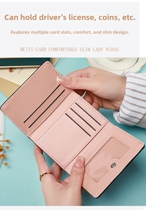 Detail view of pink women's tri-fold wallet showing multiple card slots and clear ID window