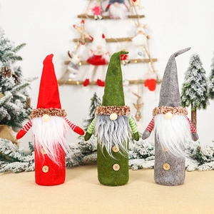 Three Christmas gnome wine bottle covers in red, green, and gray with long white beards