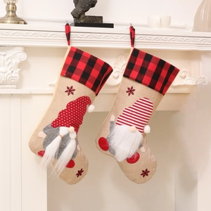 Nordic Christmas stockings featuring gnomes and red plaid cuffs on white fireplace