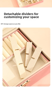 Macro detail of pink leather jewelry box featuring adjustable cream dividers for DIY storage
