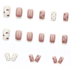 French press-on nails with heart and bow designs in pink and white tones