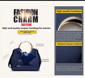 Detail of dark blue patent leather surface and golden metal ring handle for bridal bag