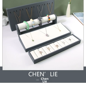 Deep grey jewelry display set with ivory fabric pads for necklaces and rings