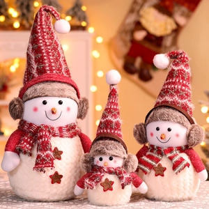 Three oversized Christmas snowman plush ornaments in red and white festive hats and scarves