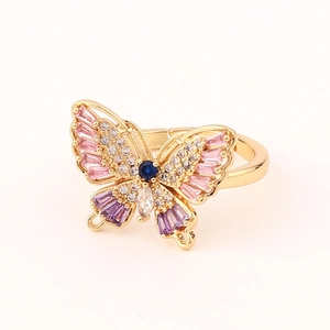 Macro detail of adjustable golden butterfly ring with colorful cubic zirconia crystals