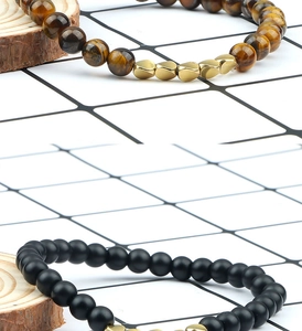 Detail of tiger eye and matte black stone beads with gold irregular metal spacers