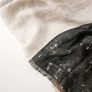 Detailed macro view of the ink wash marble texture and fringed edge on the cotton linen scarf