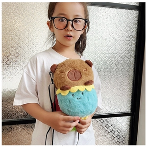 Detail view of a child wearing a cute capybara plush crossbody bag with flower base
