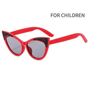 Fashionable red cat eye sunglasses for kids with black glitter accents and dark grey lenses