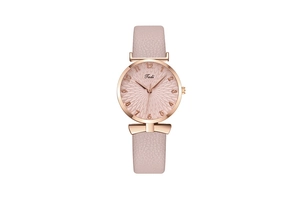 Close-up of pink textured dial with rose gold case and leather strap on a stylish watch