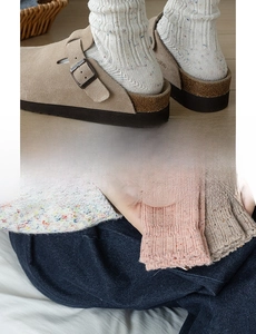 Close-up of thick knit wool socks with rainbow fleck texture in multiple colors