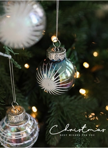 Detailed close-up of blue and silver Christmas balls with glitter hanging on a tree