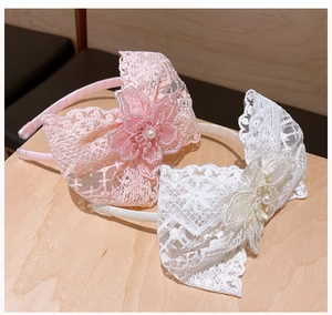 Detail of lace flower headbands with pearls and tassels for girl birthday parties