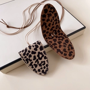 Detail of leopard print faux leather necklace pouches in brown and beige colors