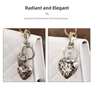 Detail of heart-shaped leopard print keychain with gold and silver metal clasps