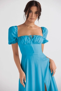 Detail of sky blue puff sleeve floral dress featuring a square neck and tie-knot bow