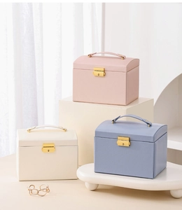 Detailed view of three-tier leather jewelry boxes with metal buckles and top handles