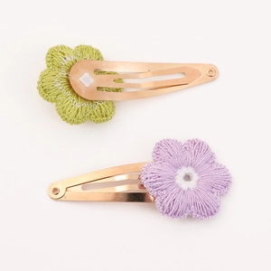 Set of two knit sunflower hair clips in avocado green and lilac purple colors