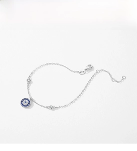 Macro shot of silver S925 Evil Eye bracelet with blue cubic zirconia and lobster clasp